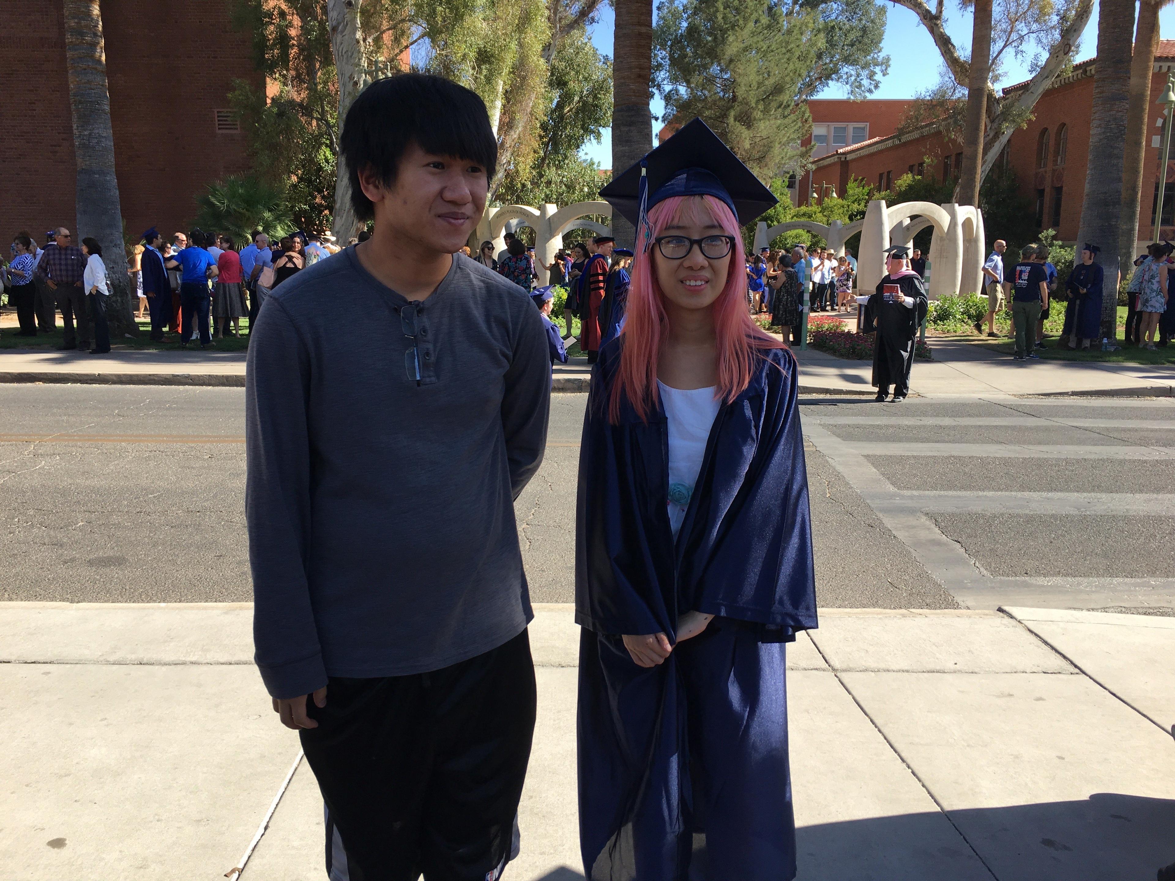 Ryan with his sister in her cap and gown at her University of Arizona graduation