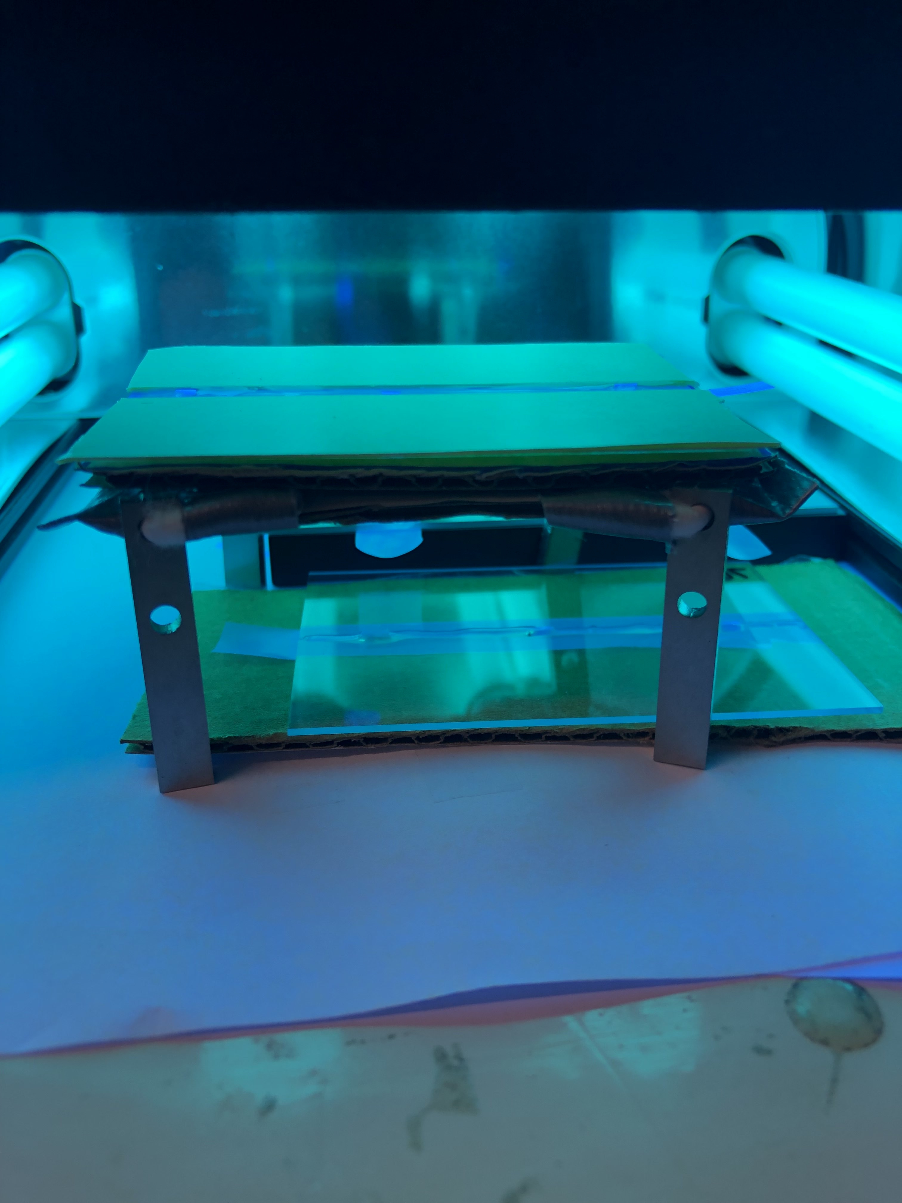Glass substrate samples curing under UV lamp array
