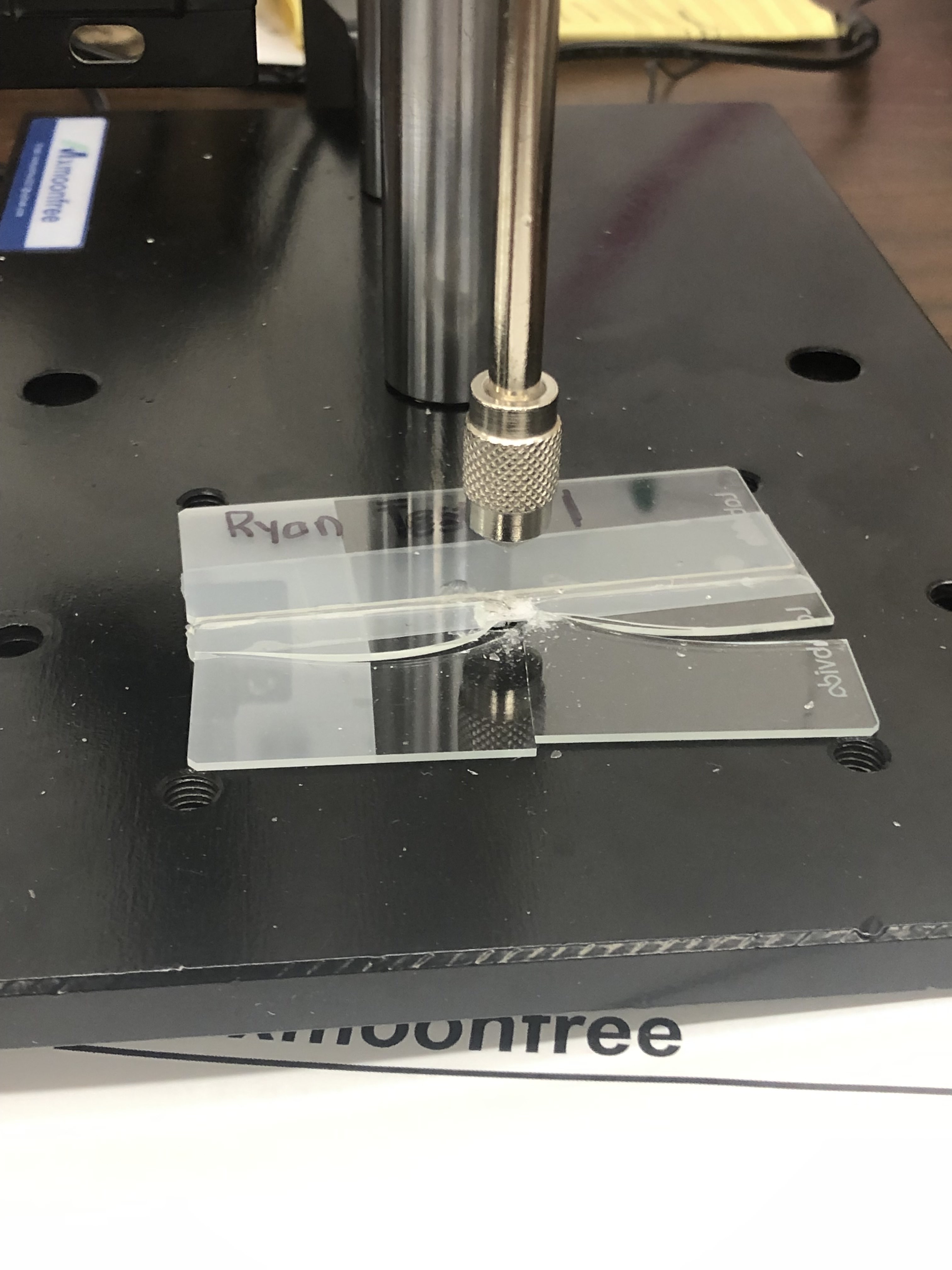 Bonded glass samples positioned on force gauge test stand
